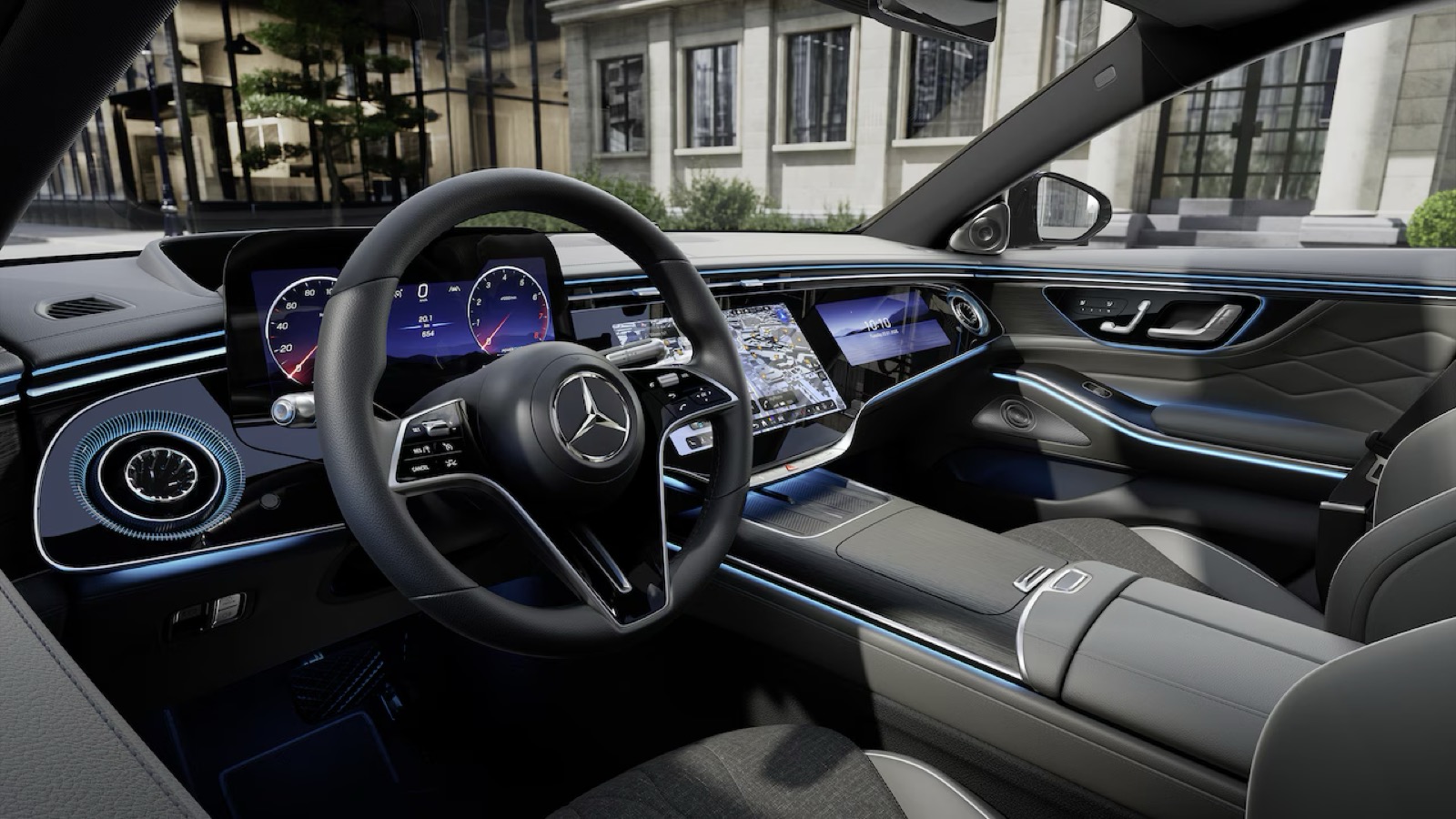 Studio photograph of the front cabin of the Mercedes flagship saloon: steering wheel, driver display and the map open on the central screen